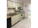 Functional kitchen equipped with essential appliances, ample cabinet space, and durable tile flooring at 4152 66Th Street W Cir # 4152, Bradenton, FL 34209