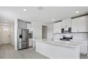 Bright kitchen featuring white cabinetry, stainless steel appliances, and quartz counters at 14118 Crutchfield Ct, Parrish, FL 34219