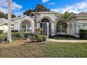 Beautifully landscaped front yard with a manicured lawn and an inviting entryway at 470 Bermuda Isles Cir, Venice, FL 34292