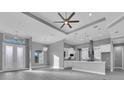 Spacious living room featuring a modern chandelier, luxury vinyl flooring, and a bar area at 193 Rotonda S Blvd, Rotonda West, FL 33947