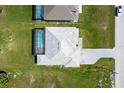 A top-down view of a single-Gathering home with a screened-in pool and paved driveway at 209 Rotonda S Blvd, Rotonda West, FL 33947