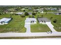 A view of a neighborhood featuring neatly landscaped homes and green lawns in Florida at 209 Rotonda S Blvd, Rotonda West, FL 33947