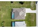 Aerial view of a single Gathering home that includes a screened-in pool and well-maintained lawn at 211 Rotonda S Blvd, Rotonda West, FL 33947