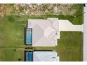 An aerial view of the home showing the roof, pool, and surrounding lush green yard at 235 Rotonda S Blvd, Rotonda West, FL 33947