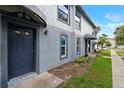 Exterior view of the townhome entrance featuring a blue front door and matching brick facade at 5112 Temple Heights Rd # B, Tampa, FL 33617