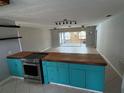 Open-concept kitchen with a wooden island, stainless steel appliances, and ample counter space, perfect for modern living at 431 David Ct, Palm Harbor, FL 34684