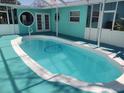 Inviting private pool with an attached covered patio perfect for outdoor relaxation and entertainment at 431 David Ct, Palm Harbor, FL 34684