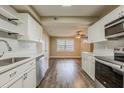 Open kitchen with stainless steel appliances, white cabinets and hardwood flooring at 4906 S 87Th St, Tampa, FL 33619