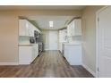 Bright kitchen featuring stainless steel appliances, white cabinets, and hardwood floors at 4906 S 87Th St, Tampa, FL 33619