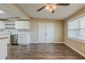 Inviting living room with hardwood floors, natural light, and access to the kitchen at 4906 S 87Th St, Tampa, FL 33619
