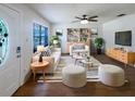 Bright and airy living room featuring modern decor, stylish furnishings, sleek ceiling fan and ample natural light at 1819 E Humphrey St, Tampa, FL 33604