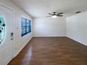 Spacious and airy living room showcasing wood flooring and a sleek ceiling fan at 1819 E Humphrey St, Tampa, FL 33604