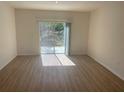 Bright living room with sliding glass doors opening to the backyard at 11330 Godwit Ave, Weeki Wachee, FL 34613
