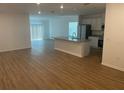 Open-concept living space with luxury vinyl flooring, flowing into the kitchen and dining area at 11330 Godwit Ave, Weeki Wachee, FL 34613