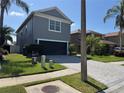 Attractive two-story home with a well-manicured lawn, brick driveway, and mature landscaping at 3721 Heron Island Dr, New Port Richey, FL 34655