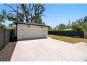 Spacious detached white garage with black accents and a large concrete parking pad at 4115 N Central Ave, Tampa, FL 33603