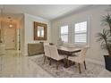 Formal dining room with elegant decor, plantation shutters, and a modern chandelier at 1966 Hyde Park St, Sarasota, FL 34239