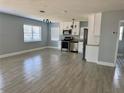 Open-concept kitchen featuring stainless steel appliances, white cabinets, and granite countertops at 3735 Alabama Ne Ave, St Petersburg, FL 33703