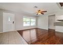 Bright living room with a ceiling fan, hardwood floors, and a view of the front yard at 8506 Moulton Dr, Port Richey, FL 34668