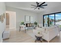 Bright living room with large sliding glass doors and stylish contemporary furnishings at 3339 Elkcam Blvd, Port Charlotte, FL 33952