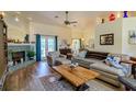 Cozy living room featuring a fireplace, plush seating, and hardwood floors at 9475 Dunkirk Rd, Spring Hill, FL 34608