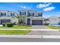 Charming two-story home boasts a manicured lawn, a two-car garage, and a beautifully landscaped yard at 3061 Hollow Hickory Pl, Wesley Chapel, FL 33543