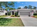 Attractive one-story home featuring a lush lawn and well-manicured landscaping at 12802 Cattail Shore Ln, Riverview, FL 33579