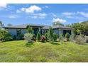 Well-manicured front yard with healthy green grass and a variety of shrubbery for added curb appeal at 268 Cory St, Port Charlotte, FL 33953