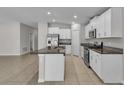 Spacious kitchen with white cabinets, granite countertops, and stainless steel appliances at 10357 Scarlet Skimmer Dr, Riverview, FL 33578