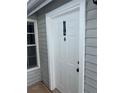 A close up of the front door with the house numbers, showing light gray siding and white trim at 12219 Armenia Gables Cir, Tampa, FL 33612