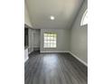The bright living room features wood floors, neutral paint, and a vaulted ceiling at 12219 Armenia Gables Cir, Tampa, FL 33612