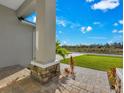 Inviting front porch with stone accents, brick pavers, and well-maintained landscaping at 205 Rotonda S Blvd, Rotonda West, FL 33947