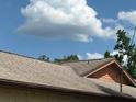 Close up shot of the roof with brown shingles and light brown trim at 23046 Brandy Rd, Land O Lakes, FL 34639