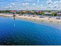Breathtaking water view showcasing the beach, clear water, and a line of charming beachfront homes at 4043 Topsail Trl, New Port Richey, FL 34652