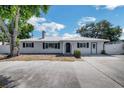 Charming single-story home with a well-maintained lawn, a metal roof and wide driveway at 5817 26Th W St, Bradenton, FL 34207