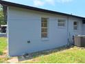The exterior of the home is painted gray and features a new air conditioning unit at 2202 Whitney Pl, Valrico, FL 33594
