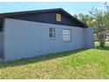 Single-story home featuring a light gray exterior with windows at 2202 Whitney Pl, Valrico, FL 33594