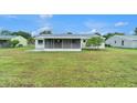 Spacious backyard featuring a covered patio, ideal for outdoor gatherings and relaxation at 5052 Trekell St, North Port, FL 34287