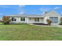 Inviting single-story home features a lovely front yard with beautiful lawn at 5052 Trekell St, North Port, FL 34287