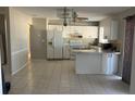 Bright eat-in kitchen with lots of tile, white cabinets, and ample counter space at 5052 Trekell St, North Port, FL 34287