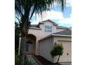 Charming two-story home with a well-maintained front yard and a two car garage at 2011 N 61St St, Tampa, FL 33619