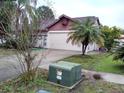Single story home with a large two car garage and well maintained yard at 2011 N 61St St, Tampa, FL 33619