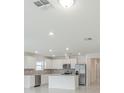 Bright kitchen features white cabinets, stainless appliances, and an island with ample counter space at 9661 Summers Cay Cir, Thonotosassa, FL 33592