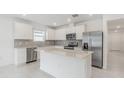 Bright kitchen featuring white cabinets, stainless steel appliances, and center island at 9661 Summers Cay Cir, Thonotosassa, FL 33592