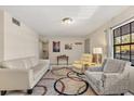 Cozy living room featuring neutral paint, tile flooring, large windows, and comfortable seating at 5744 Calais N Blvd # 4, St Petersburg, FL 33714