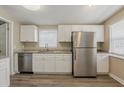 Modern kitchen featuring stainless steel appliances, white cabinets, and sleek countertops at 4010 Emerson S Ave, St Petersburg, FL 33711