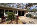 Attached carport featuring fresh plants and flowers in the front at 3141 Irving St, Sarasota, FL 34237