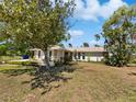 Inviting single-story home with a well-maintained lawn and mature trees provides great curb appeal at 9420 Ripley Rd, Thonotosassa, FL 33592