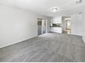 Spacious living room with neutral carpet, recessed lighting, and seamless flow into dining area at 9420 Ripley Rd, Thonotosassa, FL 33592