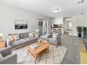 Cozy living room features neutral colors, plush carpet, and sliding doors for bright natural light at 9420 Ripley Rd, Thonotosassa, FL 33592